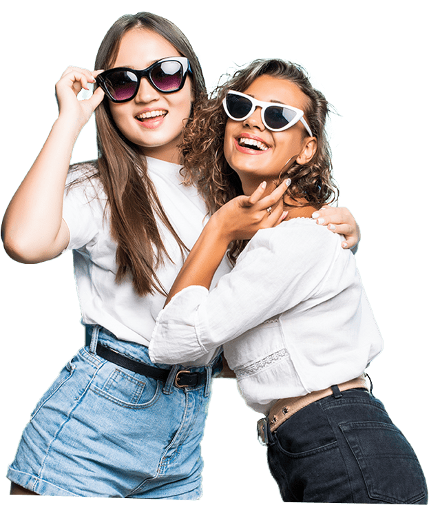 Two young adult women smiling wearing shades