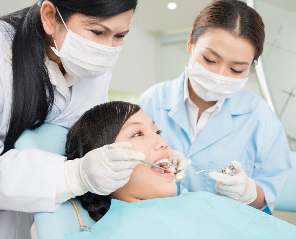 Image of a teenager having dental procedure in the clinic